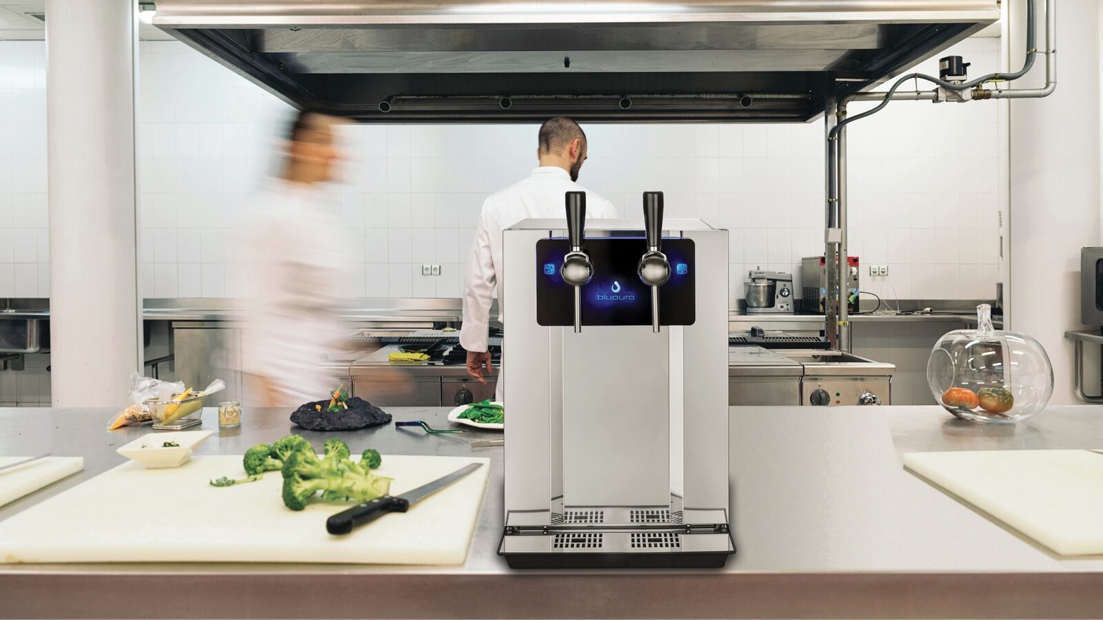 Dispensador Blupura Blubar na bancada de uma cozinha profissional durante o serviço.
